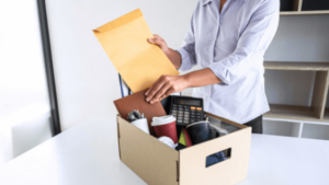 woman packing work belongings into a box